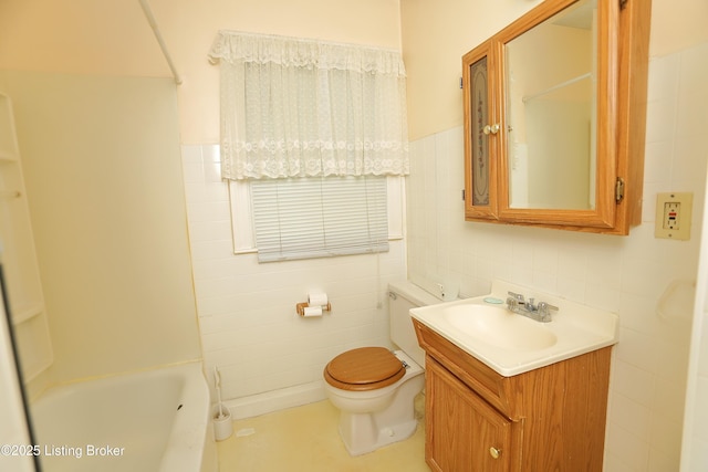bathroom with toilet, tile walls, vanity, and shower / bathing tub combination