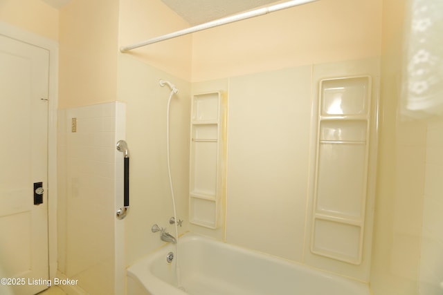 bathroom with bathing tub / shower combination
