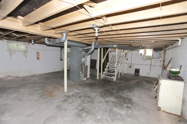 unfinished basement featuring stairway, heating unit, and electric panel