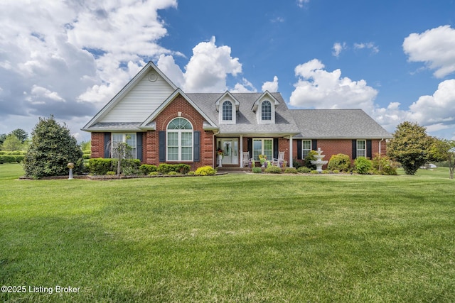 109 Terri Rose Ct, Hodgenville, KY 42748 - cape cod-style house featuring a front lawn, a shingled roof, and brick siding