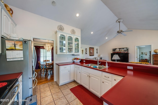 109 Terri Rose Ct, Hodgenville, KY 42748 - kitchen with lofted ceiling, white cabinetry, glass insert cabinets, a sink, and a peninsula