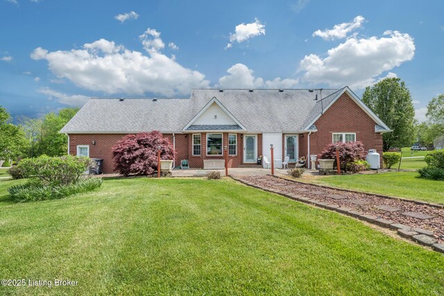 109 Terri Rose Ct, Hodgenville, KY 42748 - rear view of property featuring a patio area, a yard, a shingled roof, and brick siding
