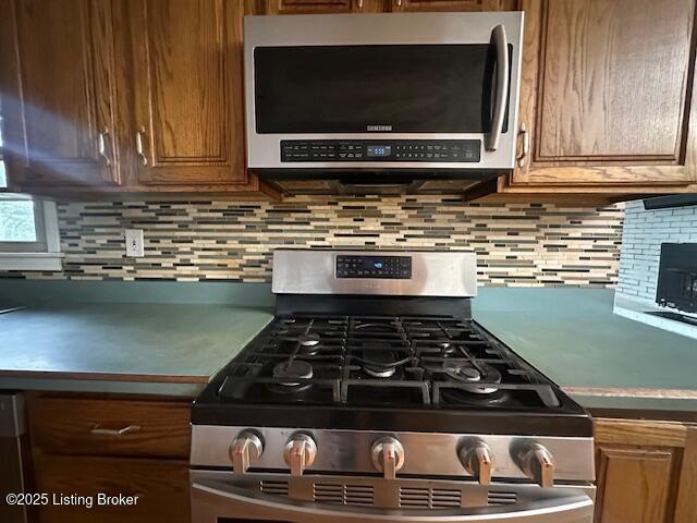 kitchen with brown cabinetry, appliances with stainless steel finishes, and decorative backsplash
