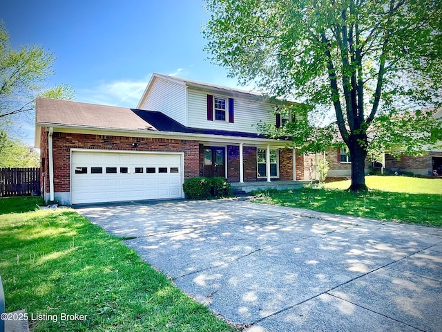 traditional-style home featuring a garage, fence, a front lawn, and driveway