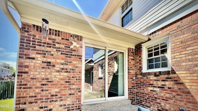 property entrance with brick siding