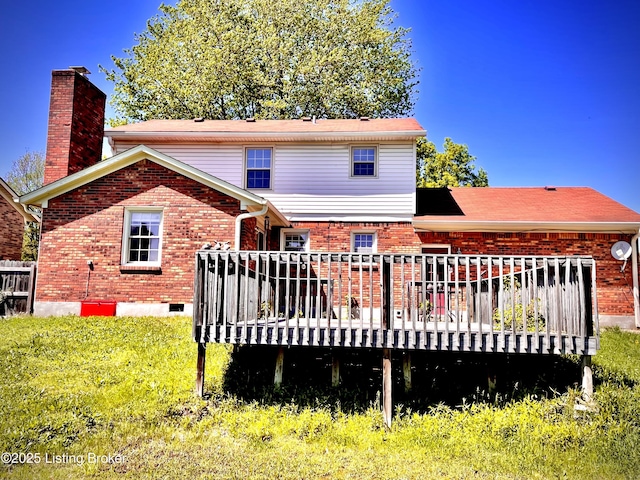 back of property featuring a wooden deck, a chimney, and brick siding
