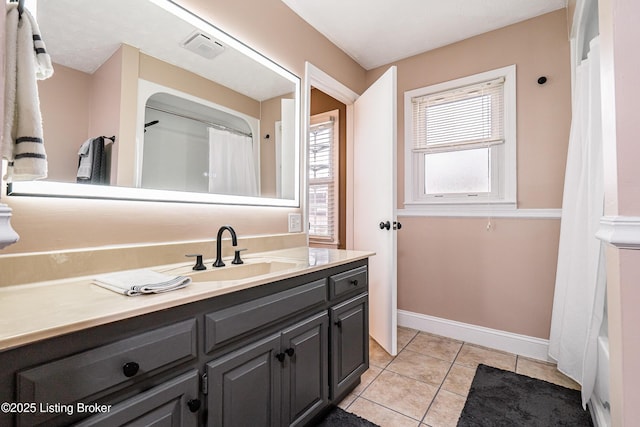 full bathroom featuring vanity, curtained shower, visible vents, baseboards, and tile patterned flooring