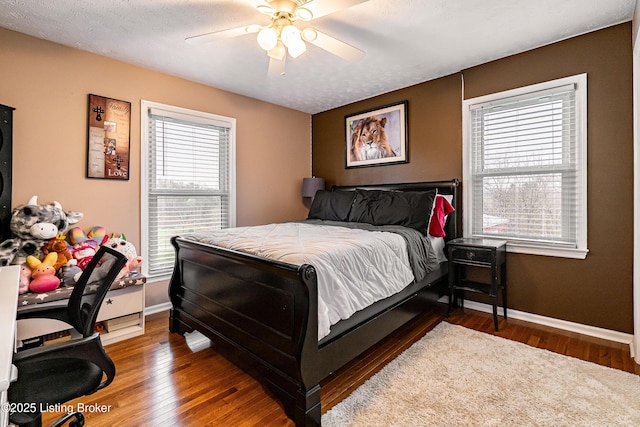 bedroom with baseboards, wood finished floors, and ceiling fan