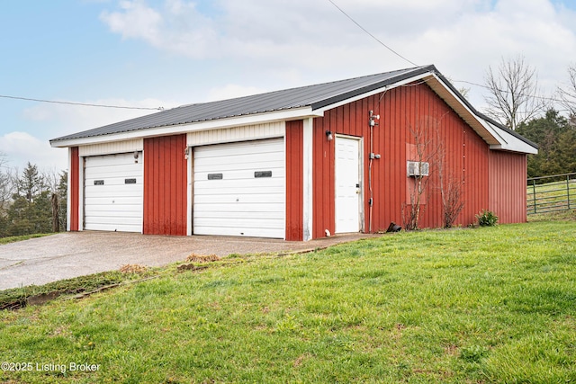 detached garage featuring fence
