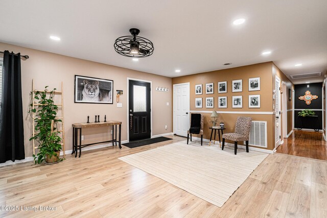 entryway featuring wood finished floors, a ceiling fan, visible vents, and recessed lighting