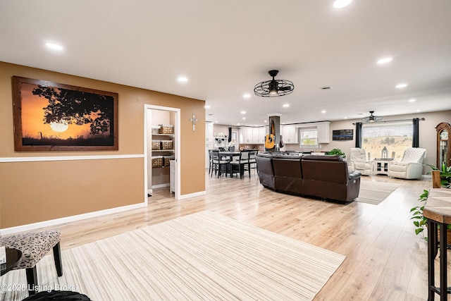 living room with recessed lighting, a ceiling fan, and light wood finished floors