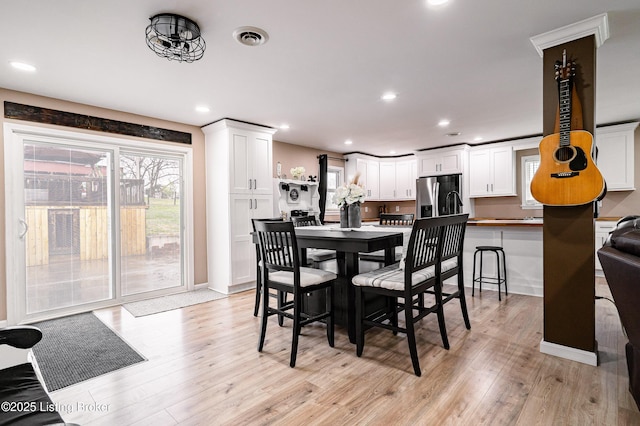 dining area with visible vents, recessed lighting, and light wood-style flooring