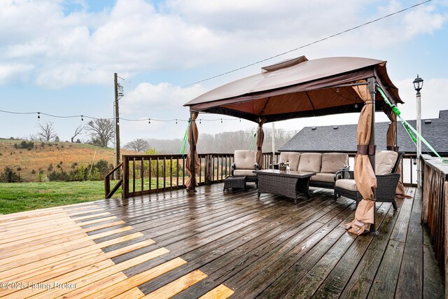 deck featuring outdoor lounge area and a gazebo