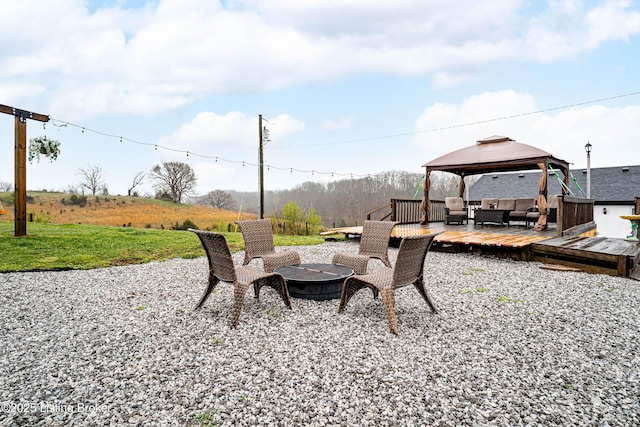 view of yard with an outdoor living space with a fire pit, a deck, and a gazebo