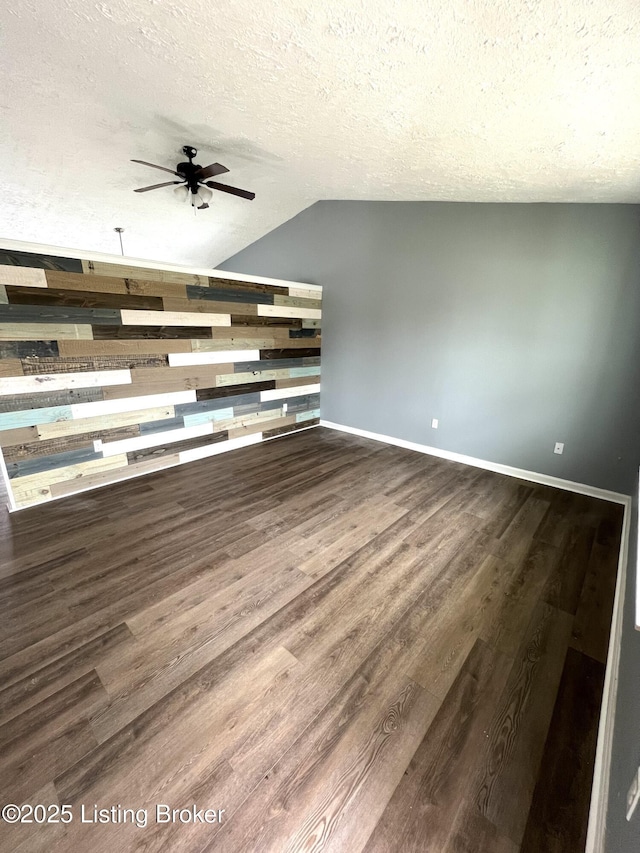 unfurnished living room featuring wood finished floors, ceiling fan, baseboards, and a textured ceiling