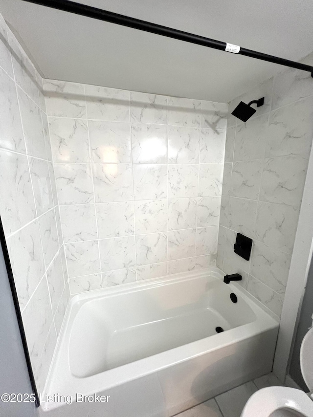 bathroom with bathing tub / shower combination and toilet