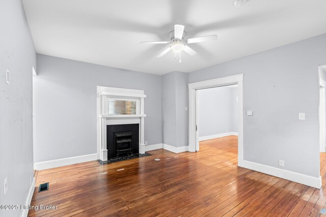 415 Gwendolyn St, Louisville, KY 40203 - unfurnished living room with a fireplace with flush hearth, ceiling fan, wood-type flooring, and baseboards