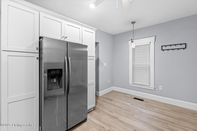 415 Gwendolyn St, Louisville, KY 40203 - kitchen with stainless steel fridge, baseboards, light wood-style flooring, ceiling fan, and white cabinets