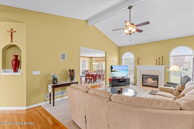 living room featuring visible vents, ceiling fan with notable chandelier, light wood-style floors, and plenty of natural light