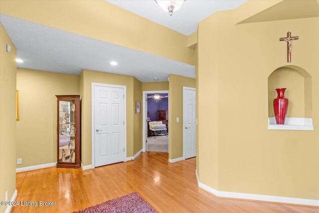 interior space with baseboards, recessed lighting, and wood finished floors