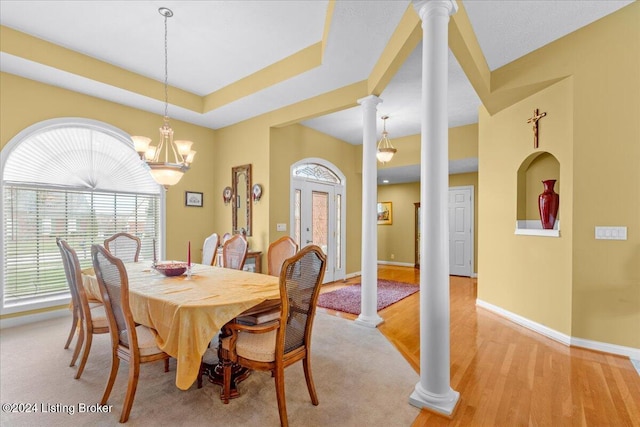dining room with baseboards, decorative columns, and light wood-style floors