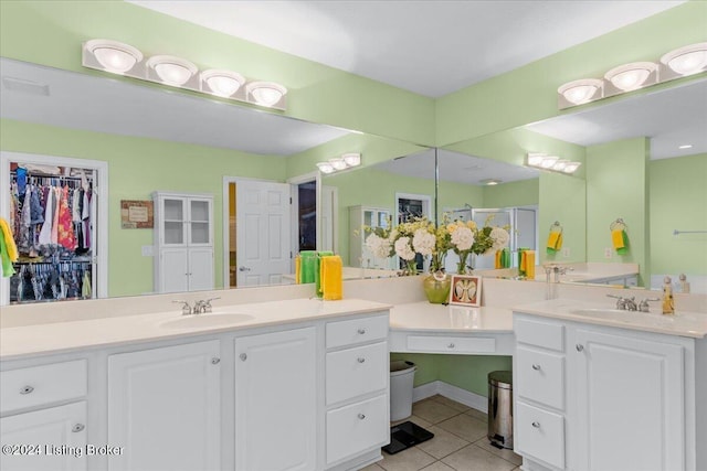 bathroom featuring tile patterned flooring, a shower stall, and vanity