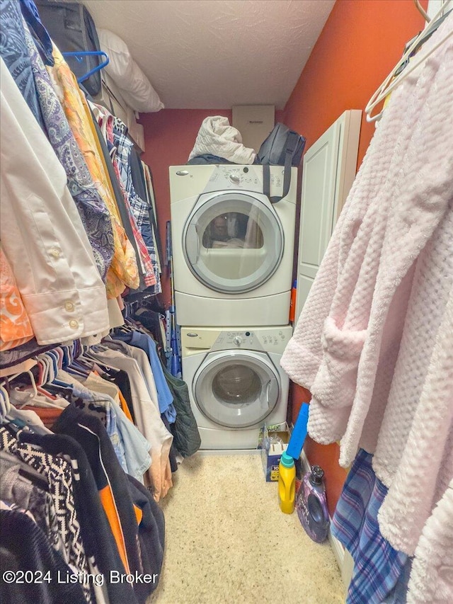 laundry room with stacked washer and clothes dryer, laundry area, and carpet floors