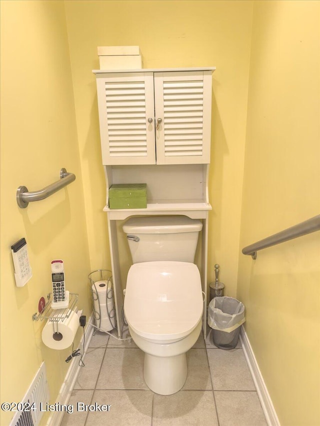 bathroom with toilet, tile patterned floors, and baseboards