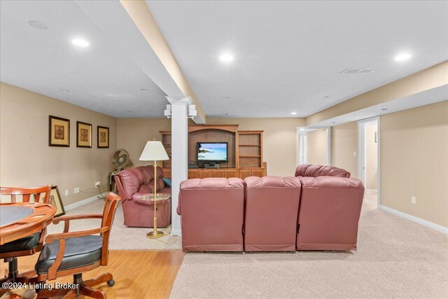 living area with baseboards, recessed lighting, and light carpet