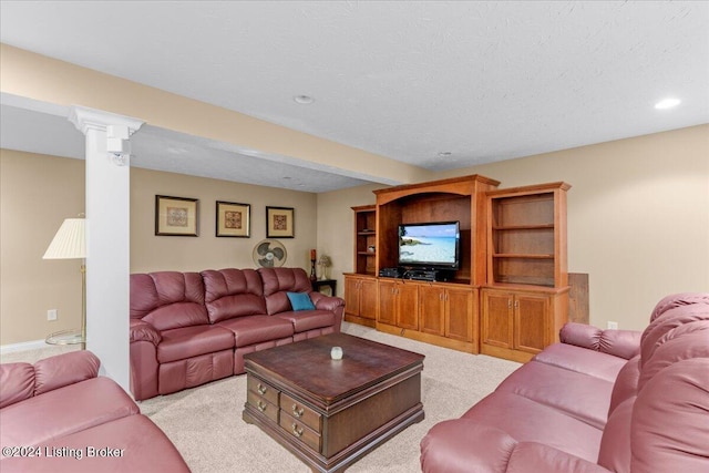 living area featuring decorative columns, recessed lighting, and light carpet