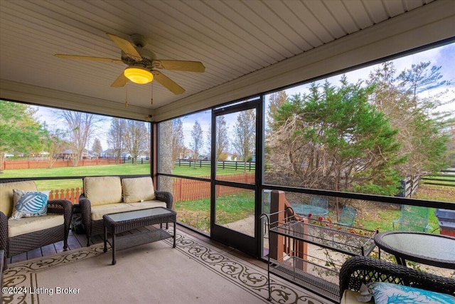 sunroom with an outdoor hangout area and a ceiling fan