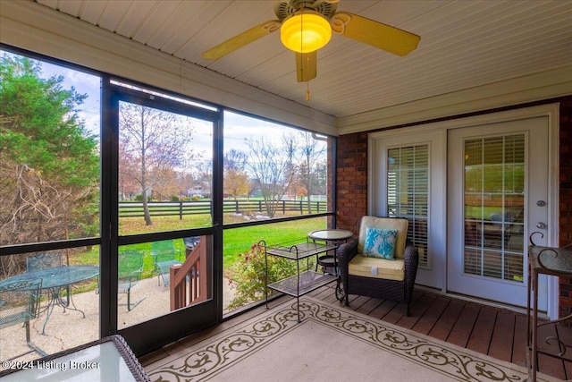 sunroom / solarium featuring ceiling fan
