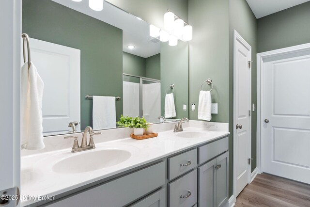 1332 Etawah Ave, Louisville, KY 40222 - bathroom featuring double vanity, a stall shower, and wood finished floors