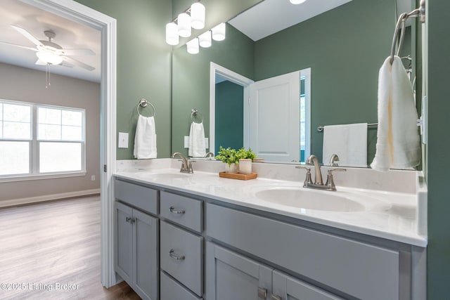 1332 Etawah Ave, Louisville, KY 40222 - bathroom featuring double vanity, wood finished floors, a ceiling fan, and baseboards