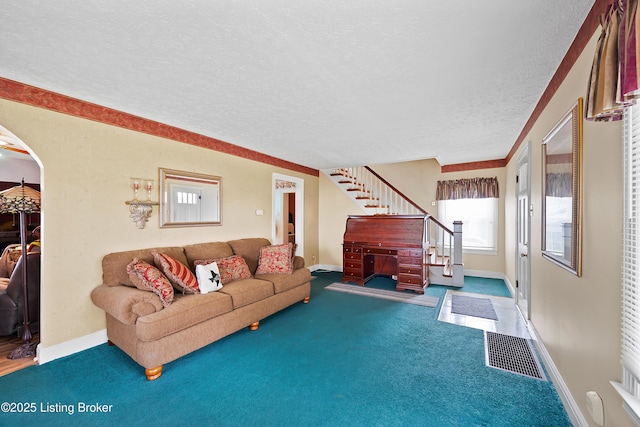 117 Fairview Dr, Waddy, KY 40076 - living room with stairway, arched walkways, baseboards, a textured ceiling, and carpet floors