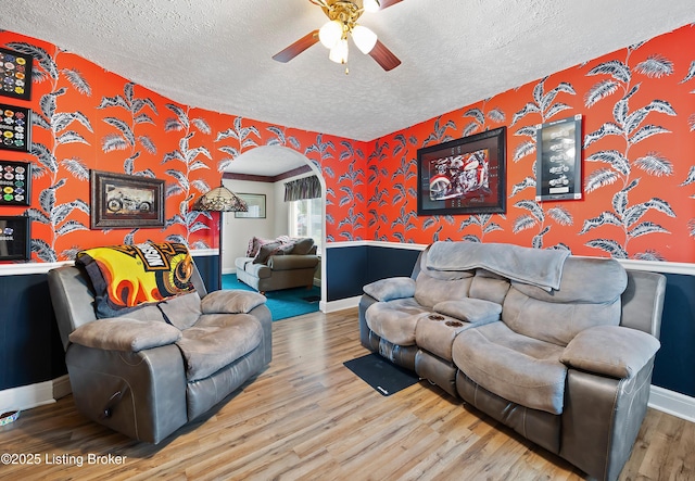 117 Fairview Dr, Waddy, KY 40076 - living room with a ceiling fan, baseboards, a textured ceiling, wallpapered walls, and wood finished floors