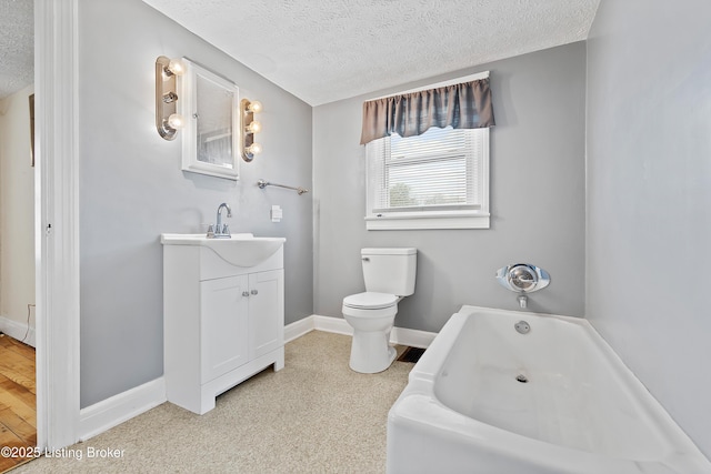 117 Fairview Dr, Waddy, KY 40076 - bathroom featuring a textured ceiling, vanity, toilet, and a bath