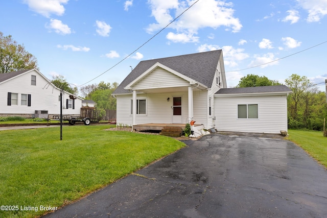 117 Fairview Dr, Waddy, KY 40076 - view of front of property with a porch, a front yard, a shingled roof, and aphalt driveway