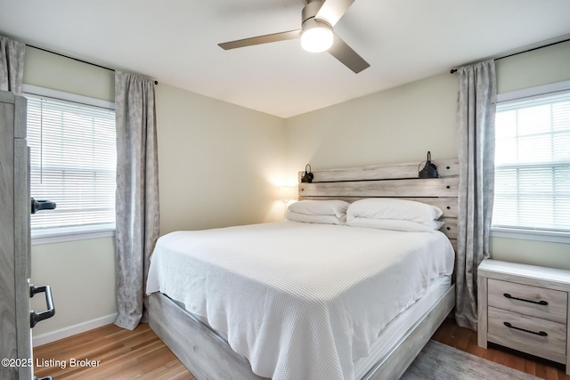 bedroom featuring wood finished floors, ceiling fan, and baseboards