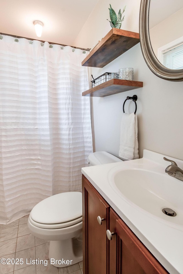 bathroom featuring vanity, toilet, a shower with shower curtain, and tile patterned flooring