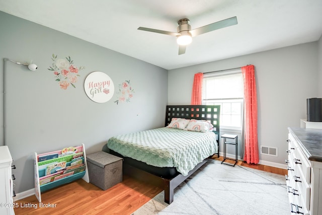 bedroom with visible vents, ceiling fan, light wood-style flooring, and baseboards