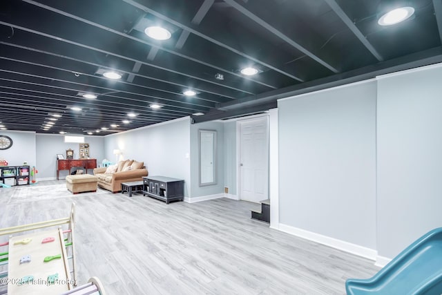 finished basement featuring wood finished floors and baseboards