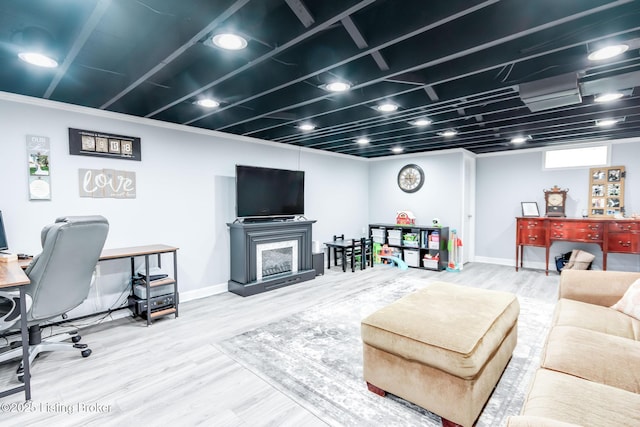 living room with a fireplace, wood finished floors, and baseboards