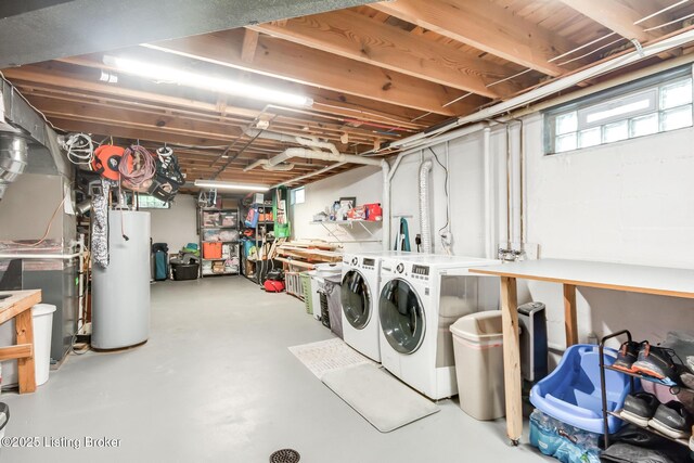 basement featuring heating unit, water heater, and washing machine and clothes dryer