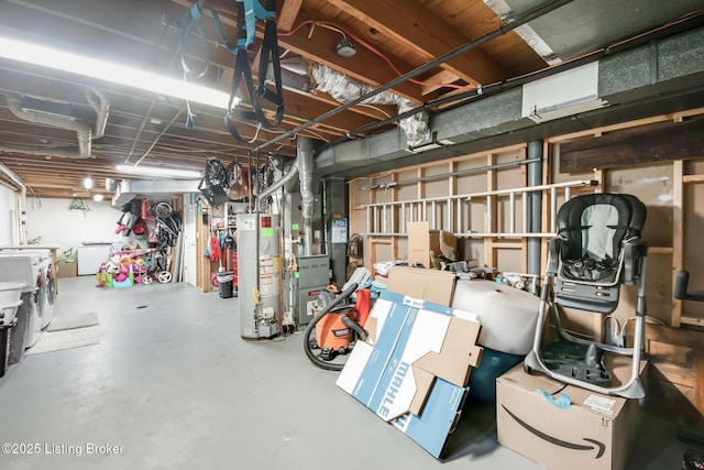 unfinished below grade area featuring heating unit, water heater, and independent washer and dryer