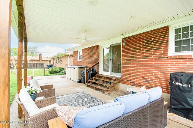 view of patio with an outdoor living space, ceiling fan, entry steps, and fence