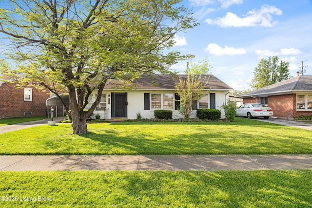 view of front of property with a front lawn, concrete driveway, and brick siding