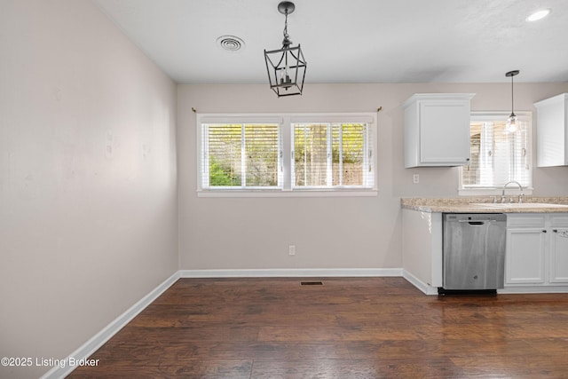 kitchen with white cabinets, dishwasher, a sink, baseboards, and visible vents