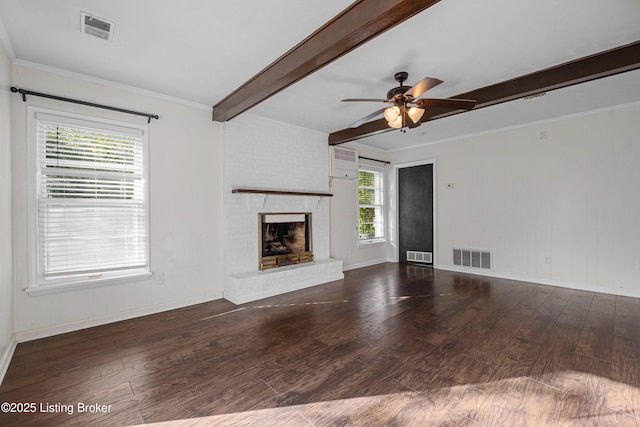 unfurnished living room with beamed ceiling, visible vents, and wood finished floors
