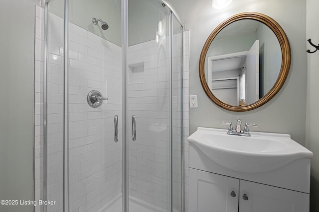 full bathroom featuring a stall shower and vanity